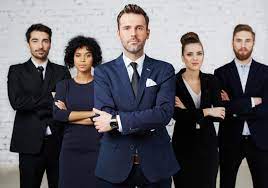 Business team standing confidently, arms crossed.